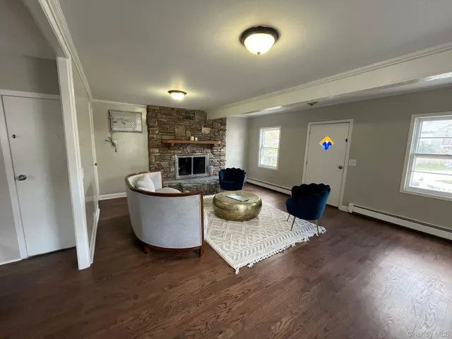 a living room with furniture and a fireplace