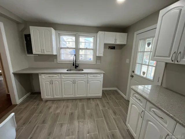 a kitchen with furniture cabinets and window