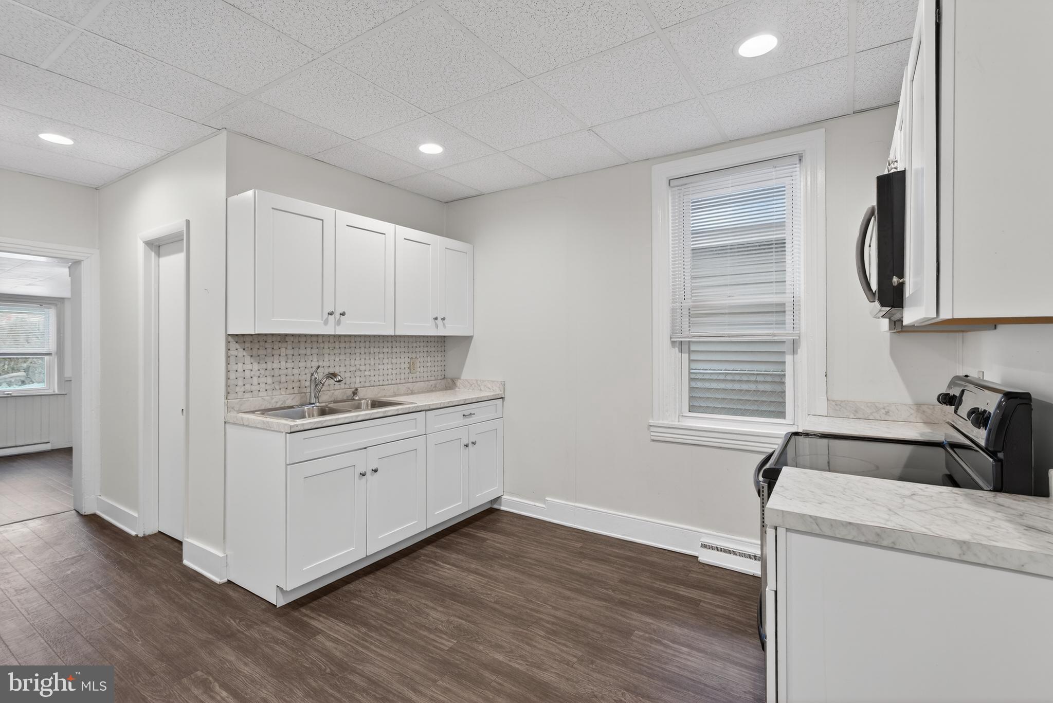 525 Walnut Street Columbia, PA 17512 - Photo 11 of 29 a kitchen with wooden floors and white appliances