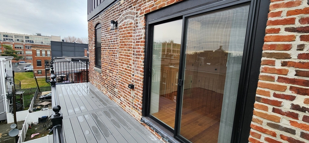 58 Lubec Street, Unit 8 Boston, MA 02128 - Photo 13 of 16 a balcony with view of residential buildings