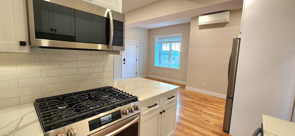 58 Lubec Street, Unit 8 Boston, MA 02128 - Photo 3 of 16 a stove top oven sitting inside of a kitchen