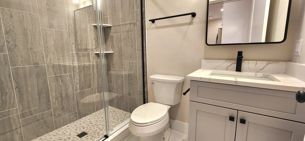 58 Lubec Street, Unit 8 Boston, MA 02128 - Photo 10 of 16 a bathroom with a sink toilet and shower