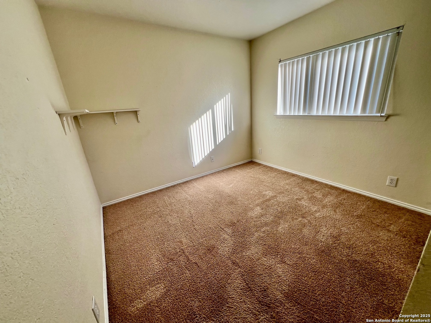 10134 Ranger Canyon San Antonio, TX 78251 - Photo 18 of 22 a view of an empty room with a window