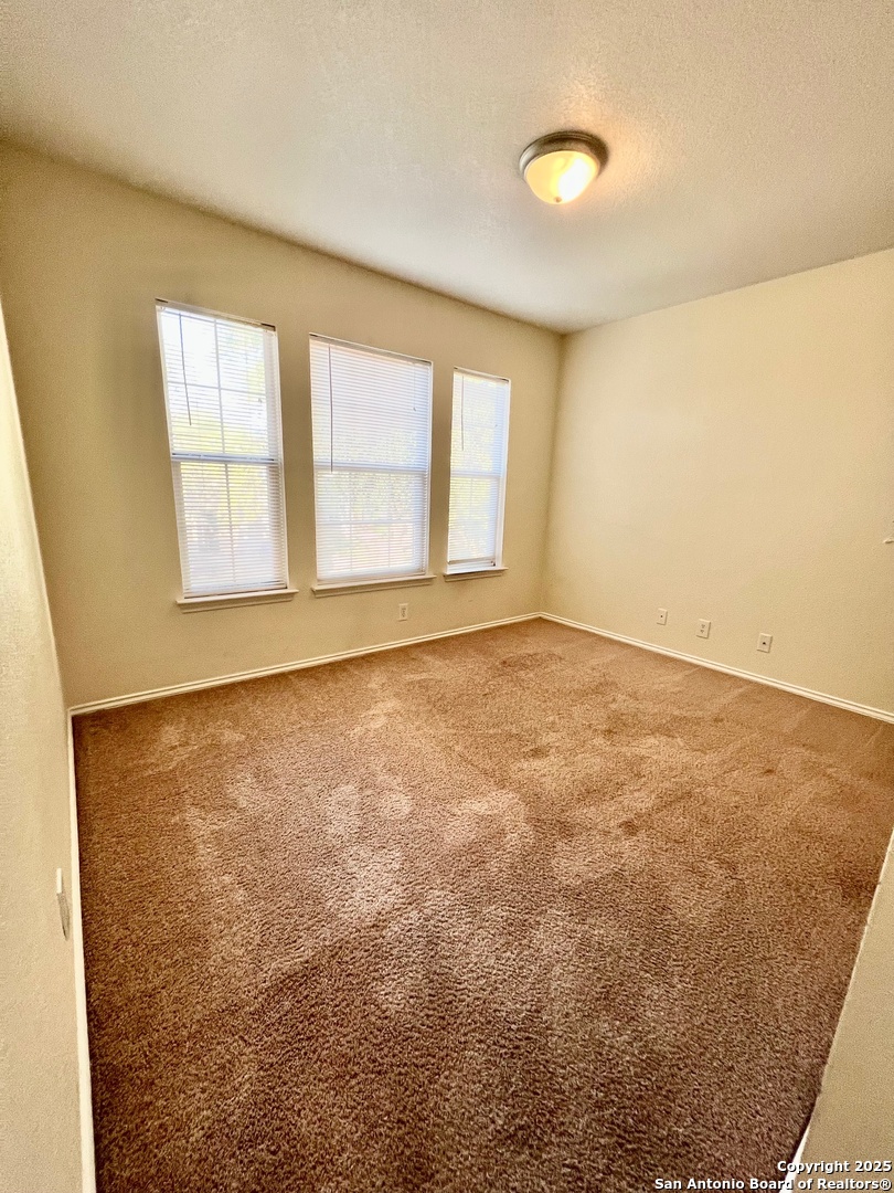 10134 Ranger Canyon San Antonio, TX 78251 - Photo 19 of 22 a view of an empty room with a window