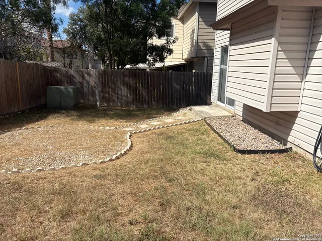 a view of a house with backyard and garage