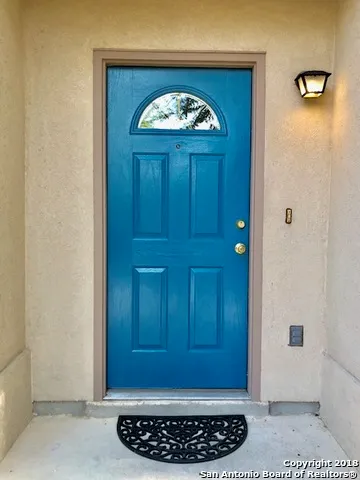 a view of a entryway door with wooden floor