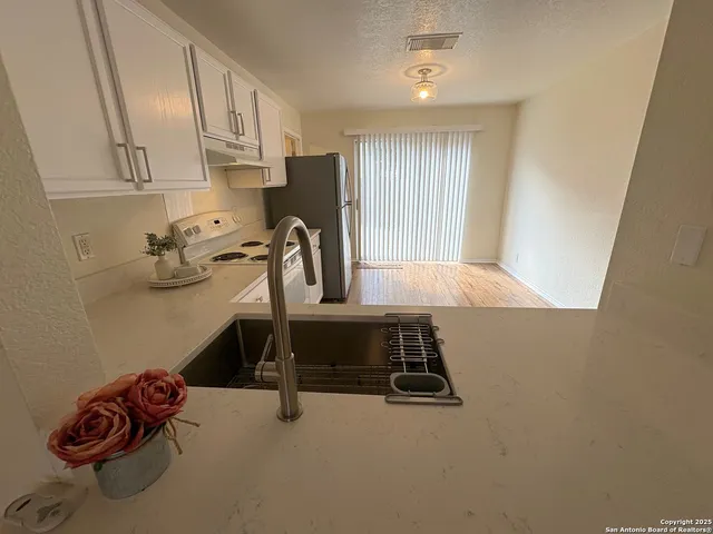a view of a kitchen with appliances and cabinets