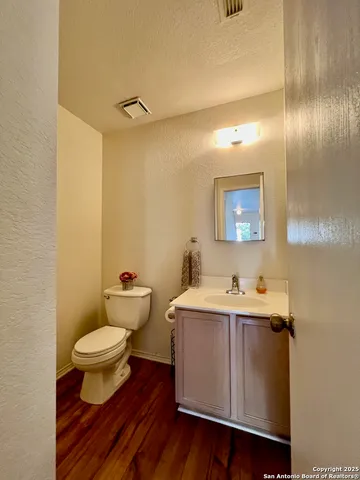 a view of bathroom with a toilet sink and mirror