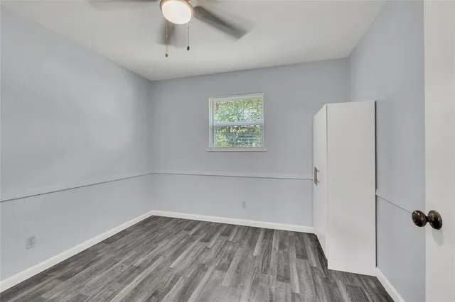 a view of room with hardwood floor and window