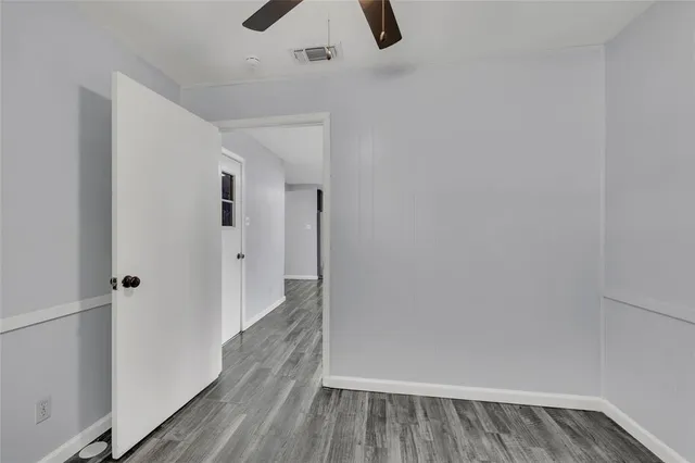 a view of a room with wooden floor