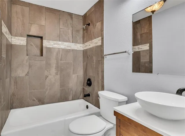 a bathroom with a toilet and a bathtub