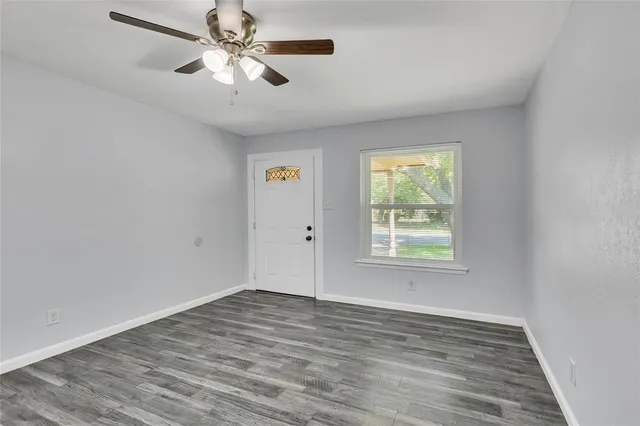 wooden floor in an empty room with a window