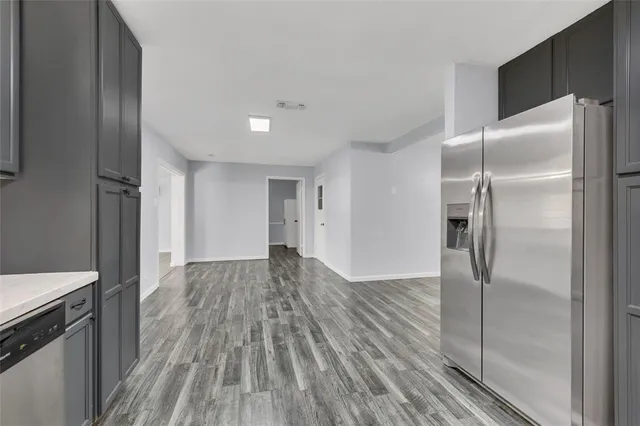 a view of a refrigerator in kitchen and wooden floor