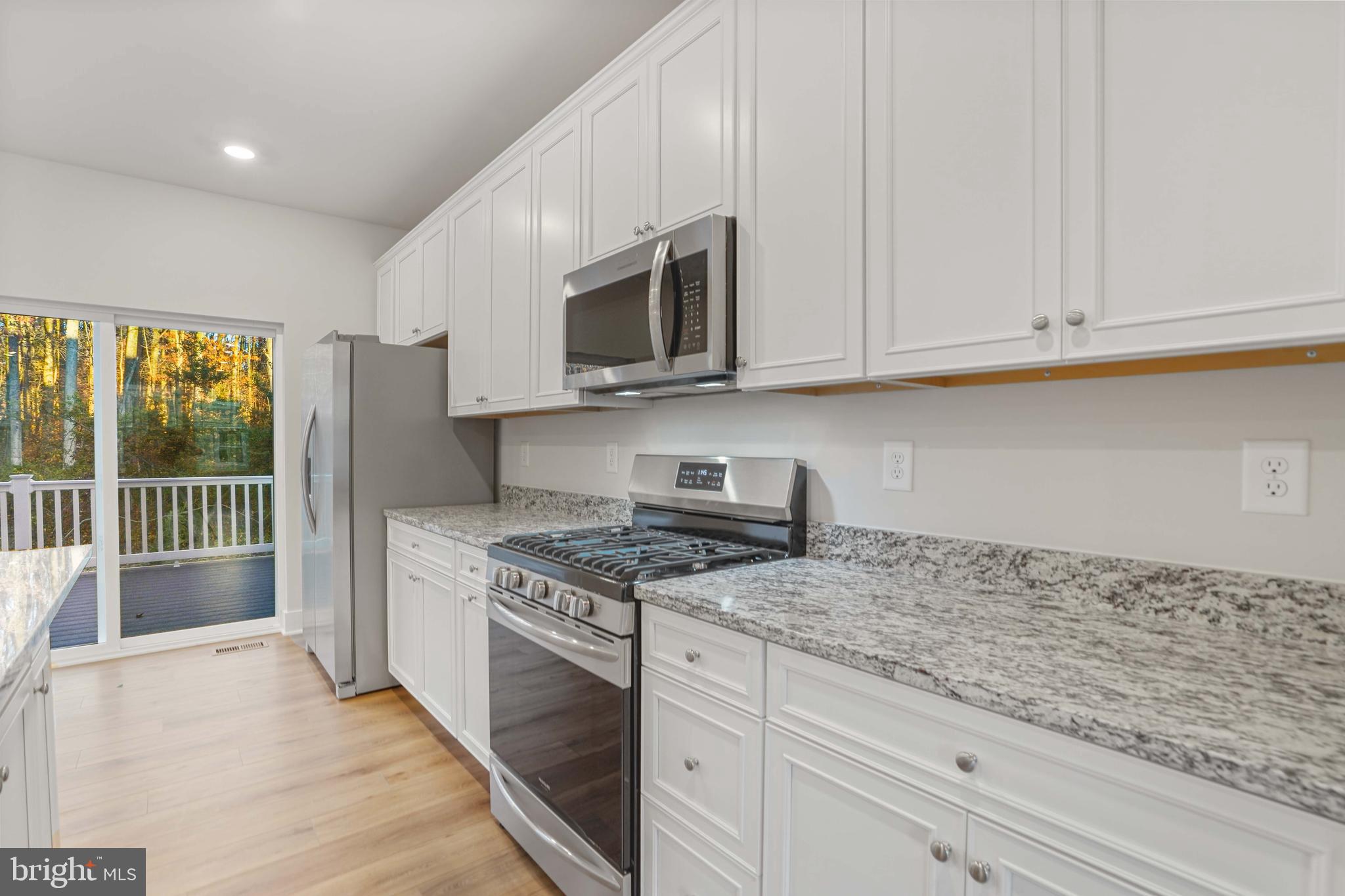 252 Waterstone Road Essex, MD 21221 - Photo 11 of 35 a kitchen with stainless steel appliances granite countertop a stove a sink and a refrigerator