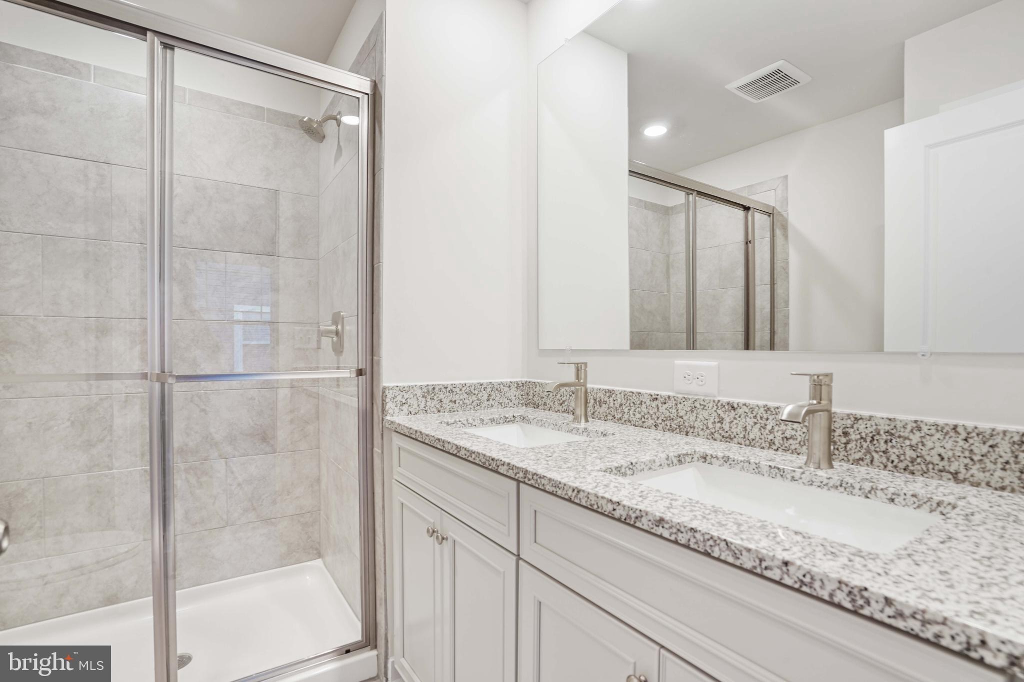 252 Waterstone Road Essex, MD 21221 - Photo 25 of 35 a bathroom with a granite countertop sink and mirror