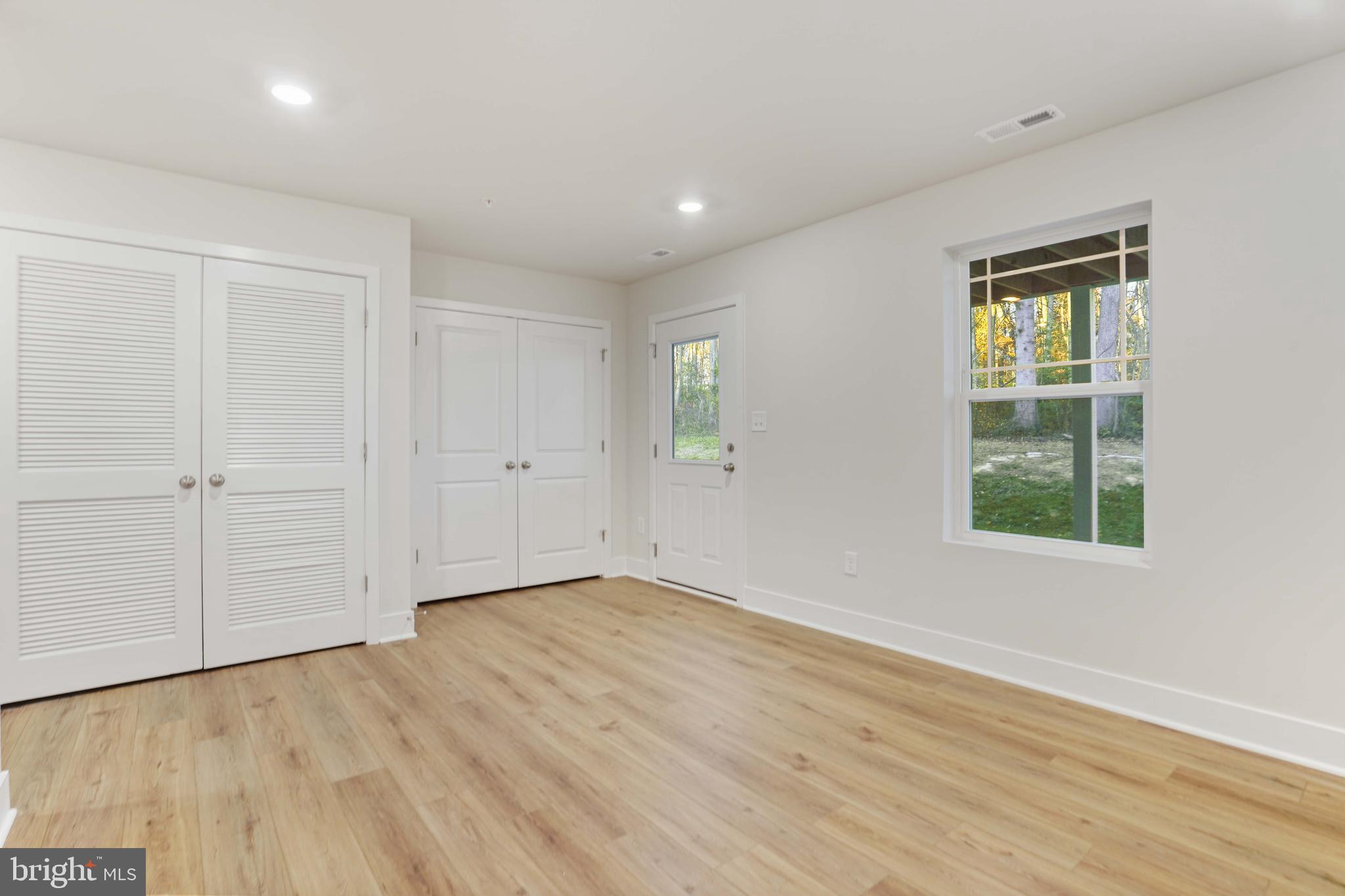 252 Waterstone Road Essex, MD 21221 - Photo 26 of 35 an empty room with wooden floor and windows