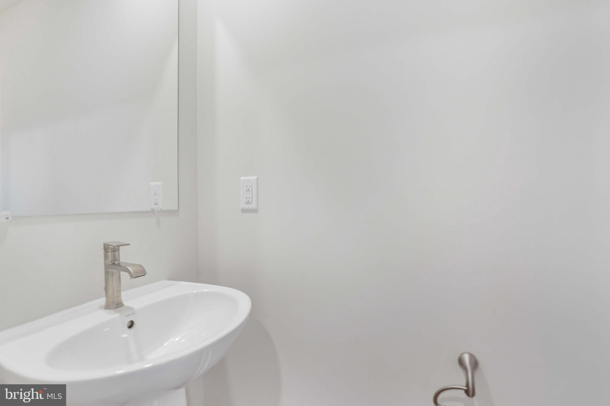 252 Waterstone Road Essex, MD 21221 - Photo 29 of 35 a bathroom with a sink and a mirror