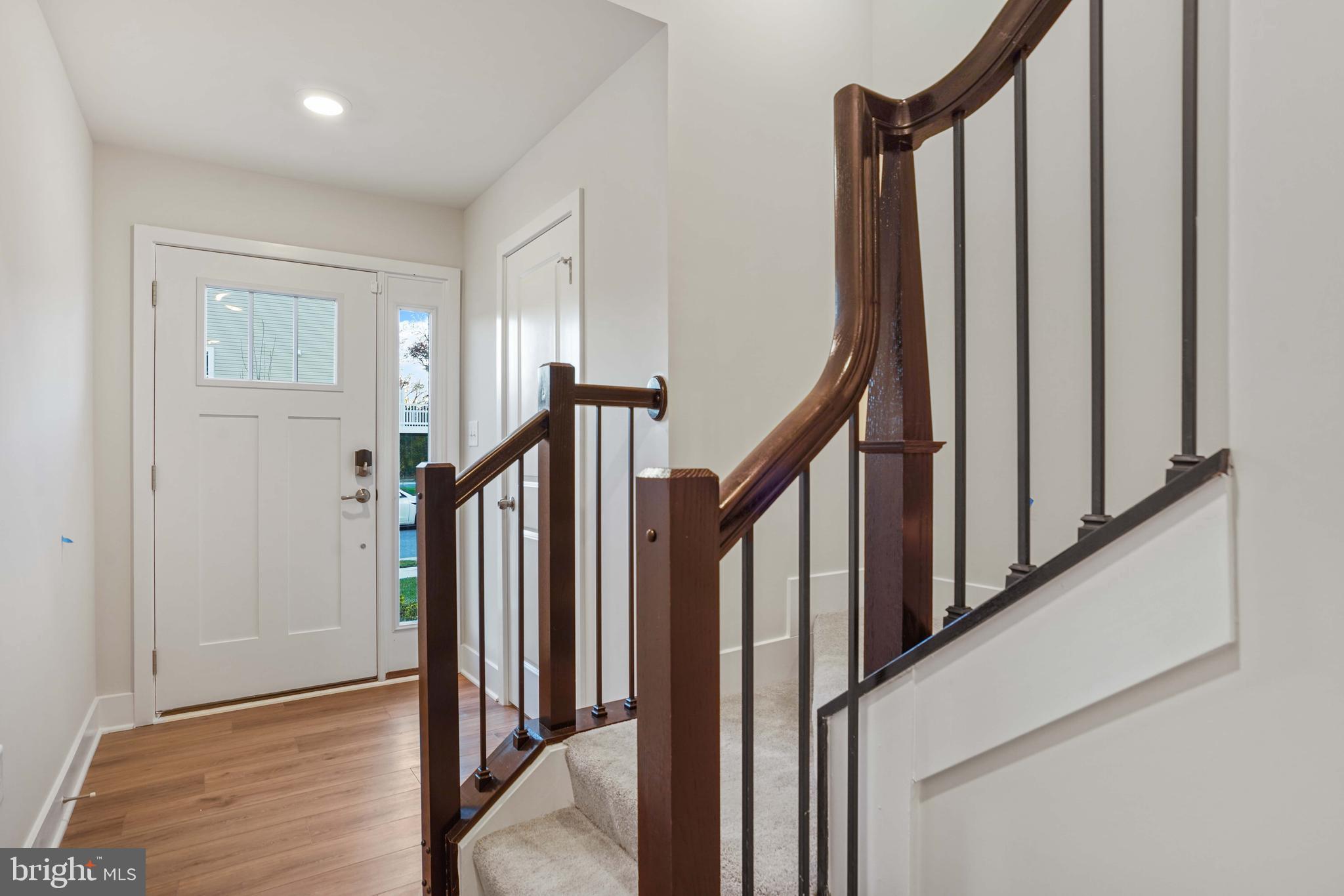 252 Waterstone Road Essex, MD 21221 - Photo 4 of 35 a view of a hallway with wooden floor and staircase