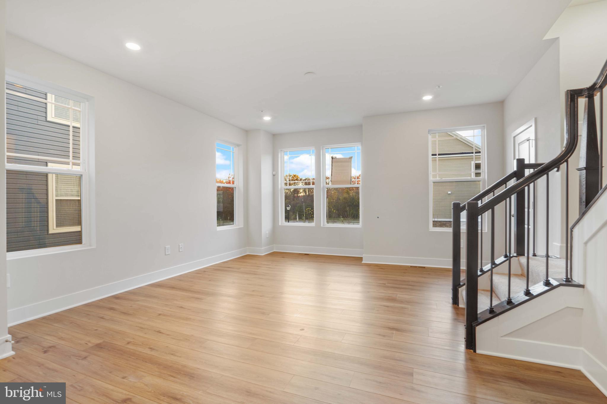 252 Waterstone Road Essex, MD 21221 - Photo 7 of 35 a view of an empty room with wooden floor and a window