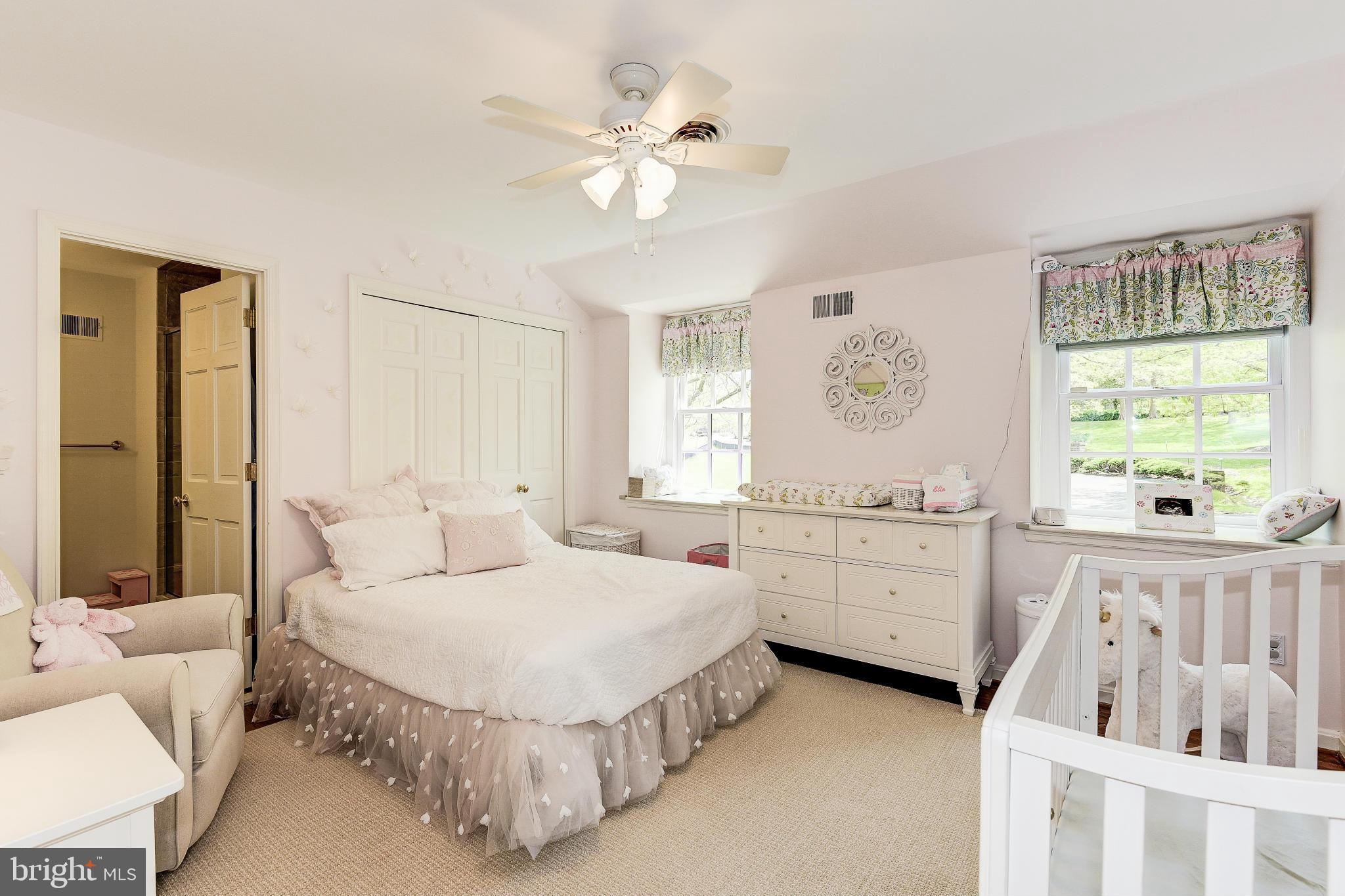 11109 Cripplegate Road Potomac, MD 20854 - Photo 19 of 31 a spacious bedroom with a bed a couch and a window