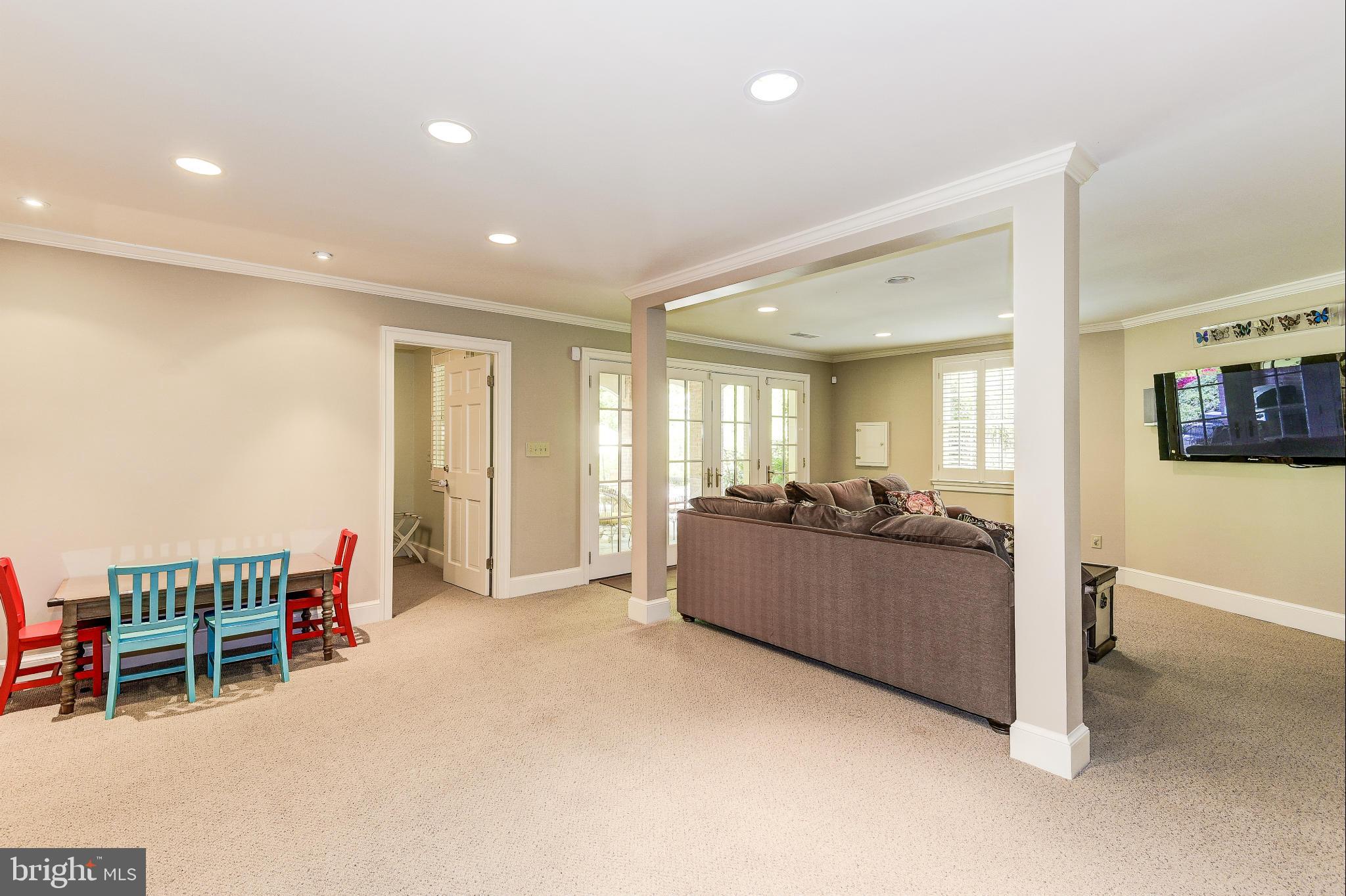 11109 Cripplegate Road Potomac, MD 20854 - Photo 22 of 31 a living room with furniture a dining table and a flat screen tv