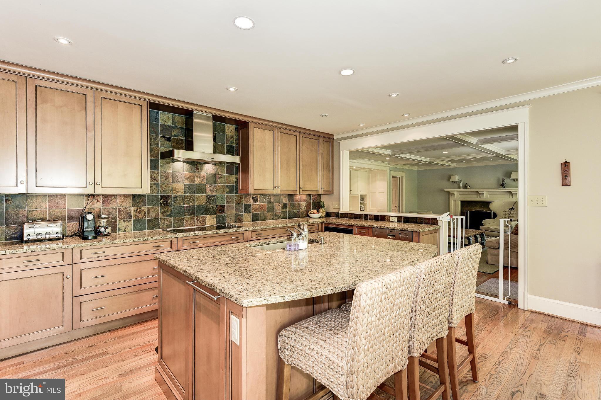 11109 Cripplegate Road Potomac, MD 20854 - Photo 6 of 31 a kitchen with center island table and chairs