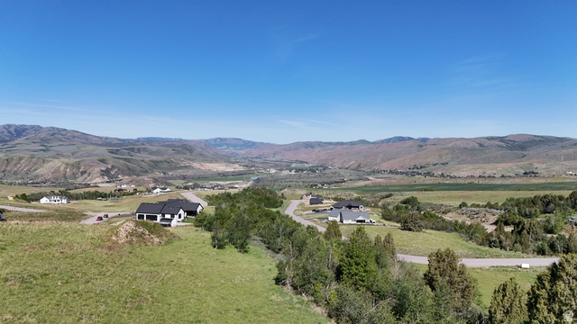 1398 Mogul Lane, Unit 1 Inkom, ID 83245 - Photo 19 of 33 Expansive high-elevation property featuring a contemporary residence with a black roof and white siding, surrounded by rolling hills and distant mountainous terrain