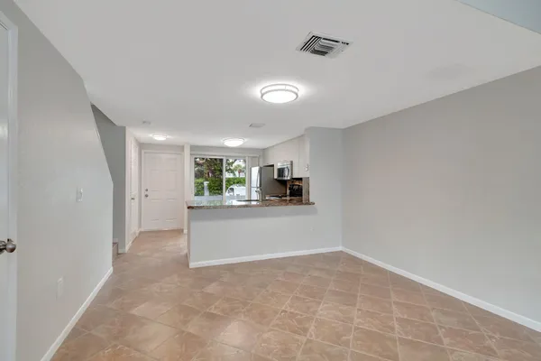 a kitchen with granite countertop white cabinets and stainless steel appliances