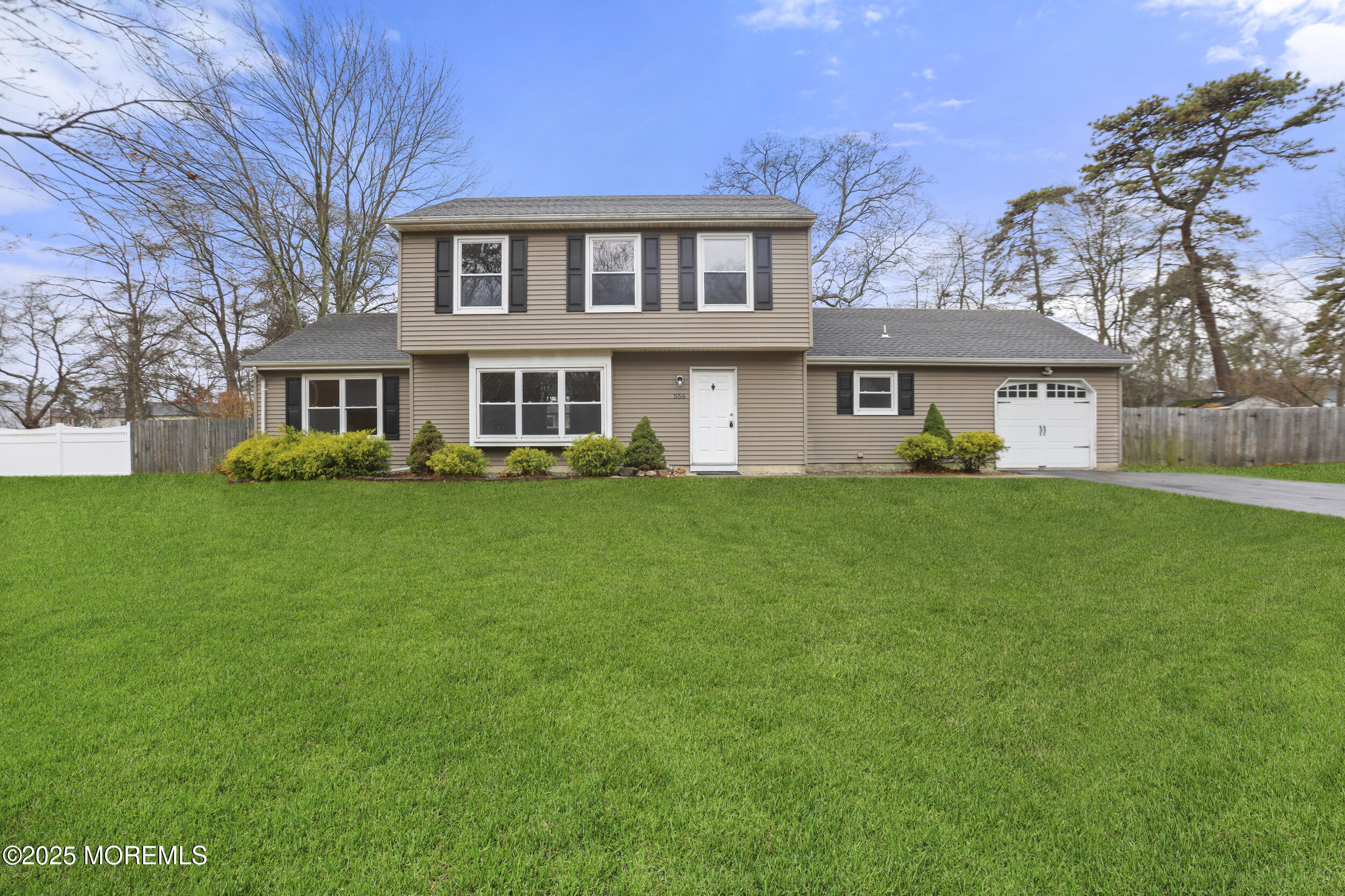 556 Kirk Lane Brick, NJ 08724 - Photo 1 of 15 a front view of house with yard and green space