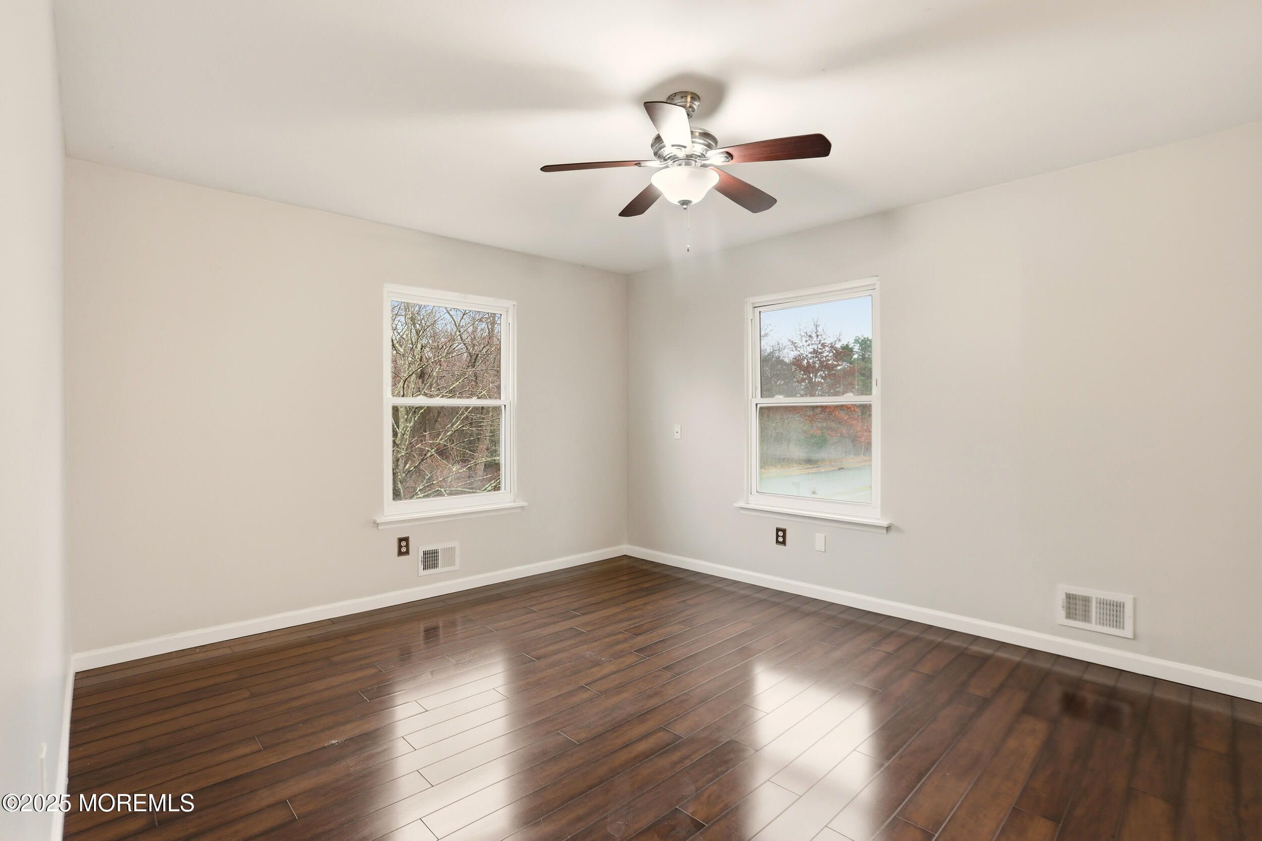 556 Kirk Lane Brick, NJ 08724 - Photo 11 of 15 a view of an empty room with wooden floor and a window