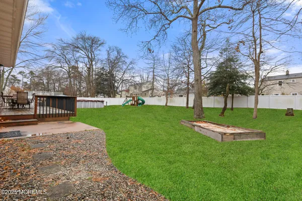 a backyard of a house with table and chairs