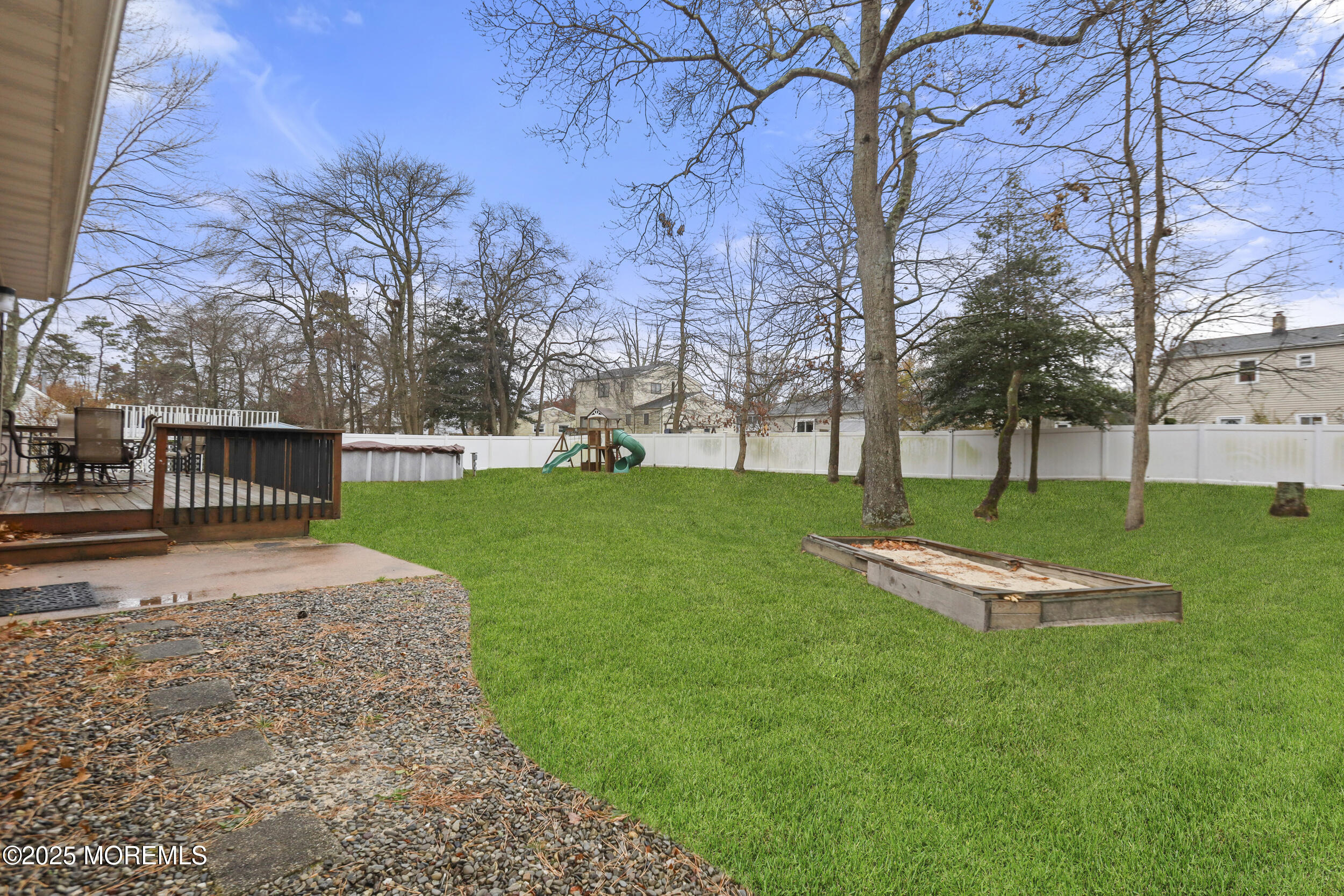 556 Kirk Lane Brick, NJ 08724 - Photo 15 of 15 a backyard of a house with table and chairs