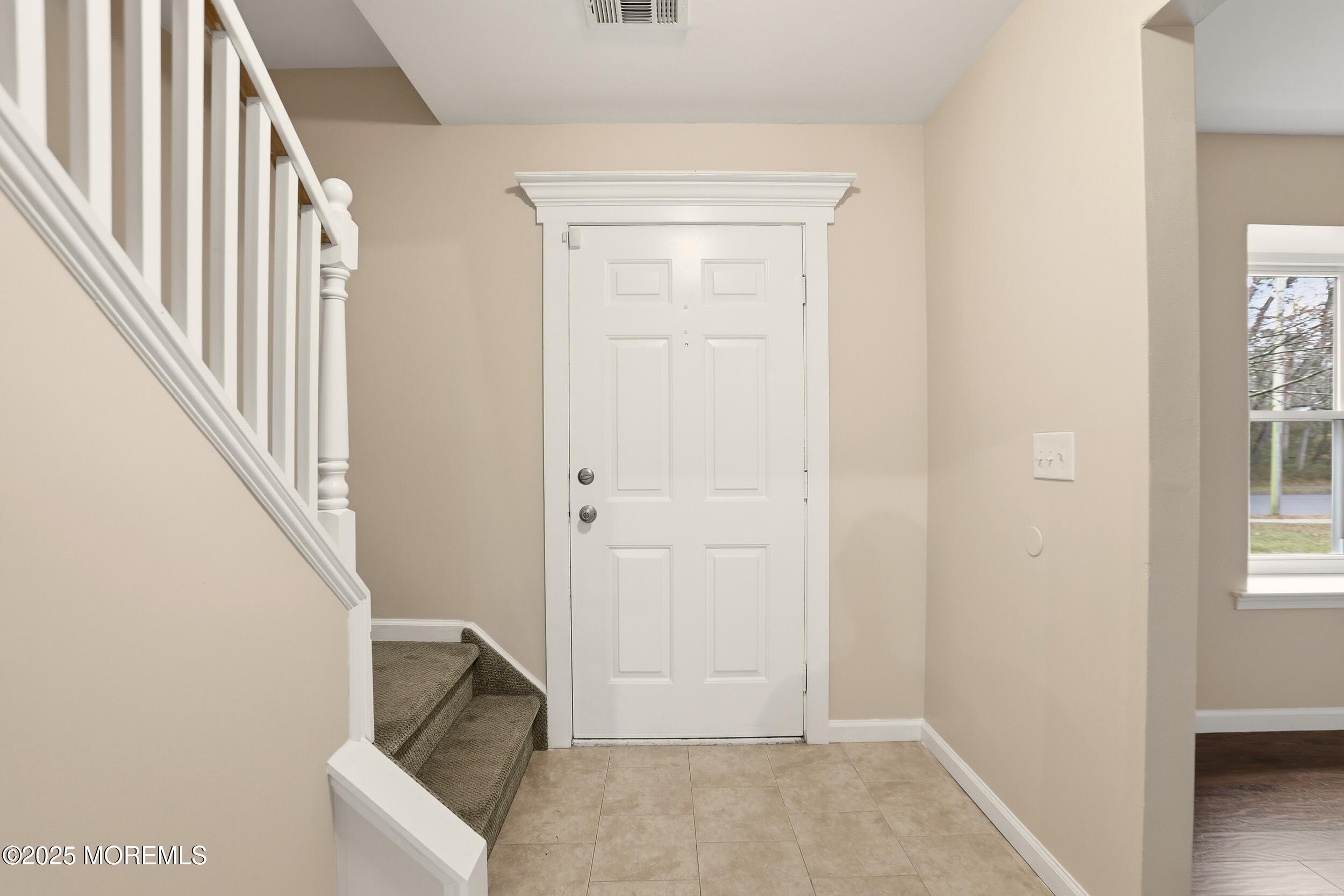 556 Kirk Lane Brick, NJ 08724 - Photo 3 of 15 an entryway with a white walls and stairs