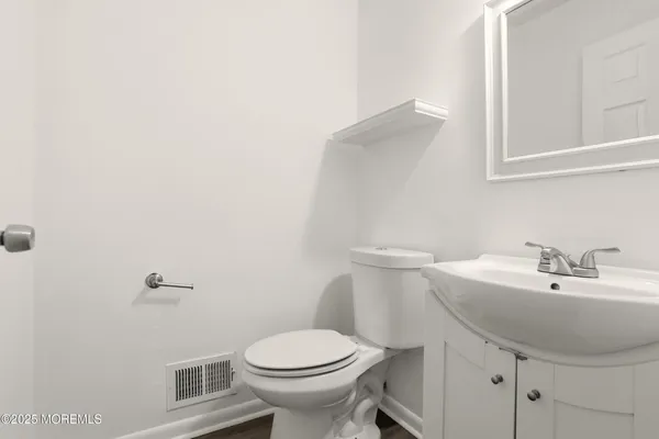 a bathroom with a sink a toilet and mirror