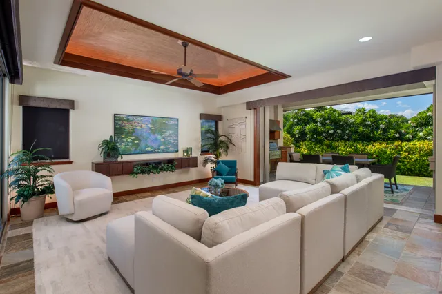 a living room with furniture a fireplace and a large window
