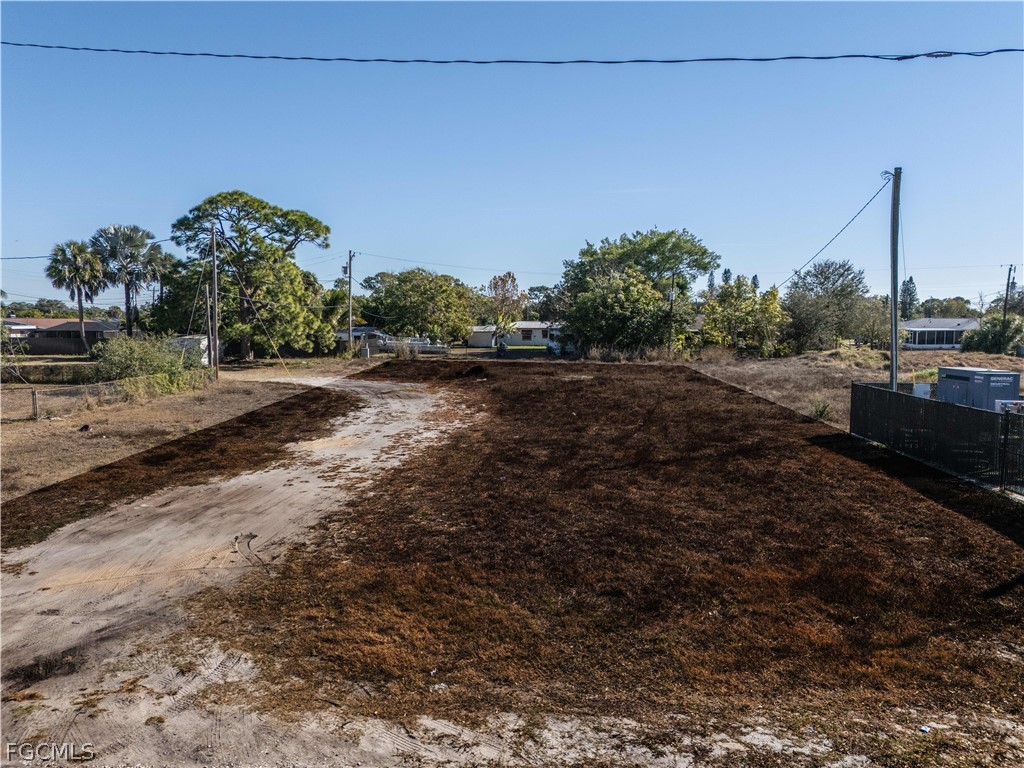 56 Illinois Road Lehigh Acres, FL 33936 - Photo 1 of 5 a view of a road with a building in the background