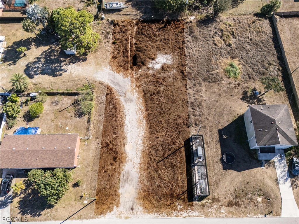 56 Illinois Road Lehigh Acres, FL 33936 - Photo 2 of 5 a view of a backyard of the house
