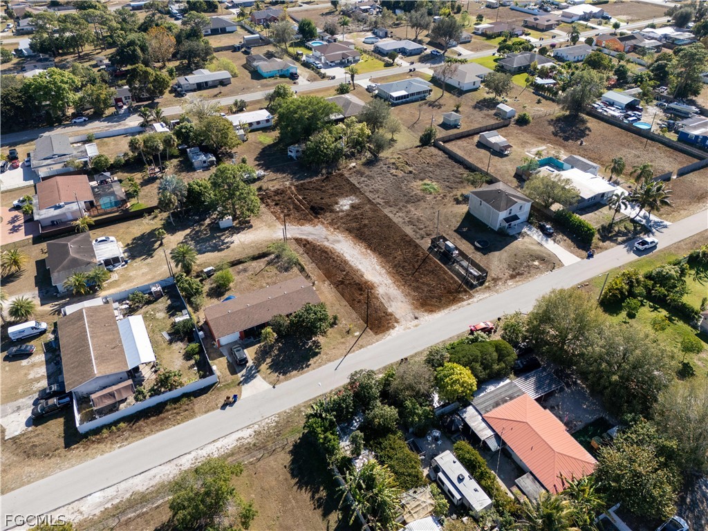 56 Illinois Road Lehigh Acres, FL 33936 - Photo 4 of 5 an aerial view of residential houses with yard