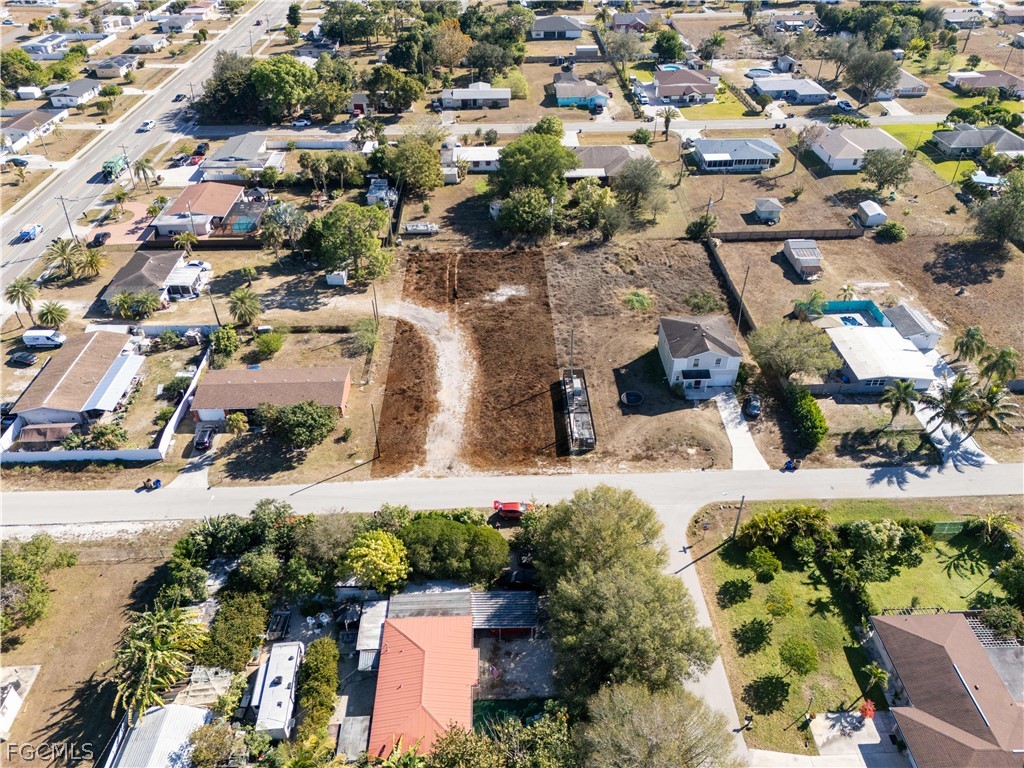 56 Illinois Road Lehigh Acres, FL 33936 - Photo 5 of 5 an aerial view of residential houses with outdoor space