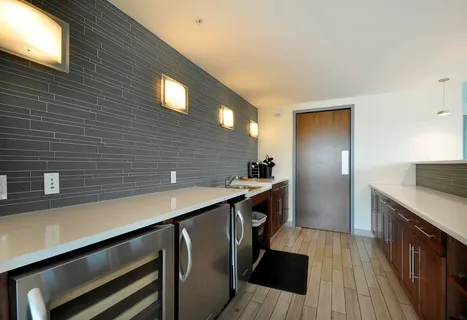 a kitchen with stainless steel appliances wooden cabinets a sink and a stove