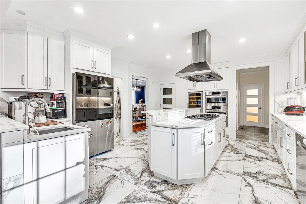 125 Union Street Natick, MA 01760 - Photo 11 of 38 a kitchen with stainless steel appliances kitchen island granite countertop a sink and cabinets
