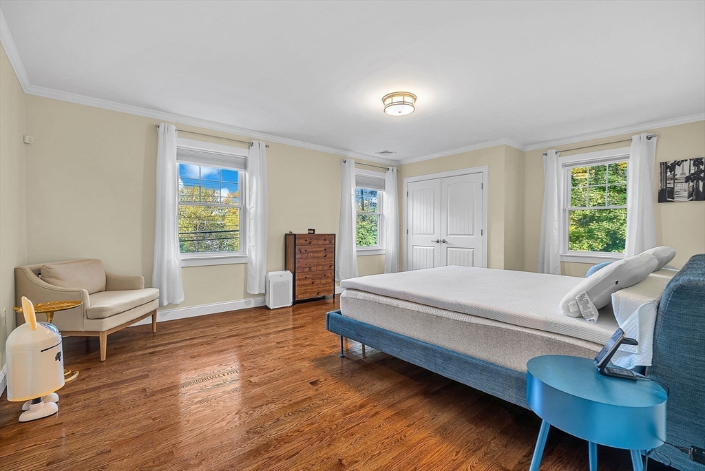 125 Union Street Natick, MA 01760 - Photo 24 of 38 a bedroom with a bed and a chair