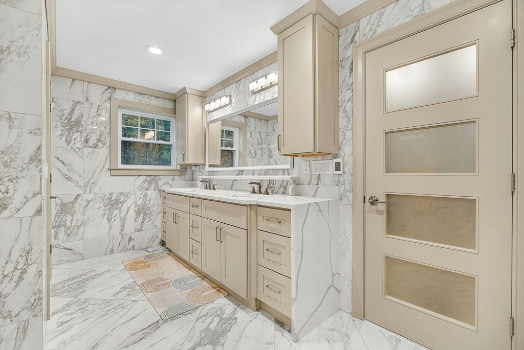 125 Union Street Natick, MA 01760 - Photo 27 of 38 a spacious bathroom with a double vanity sink a mirror and a shower