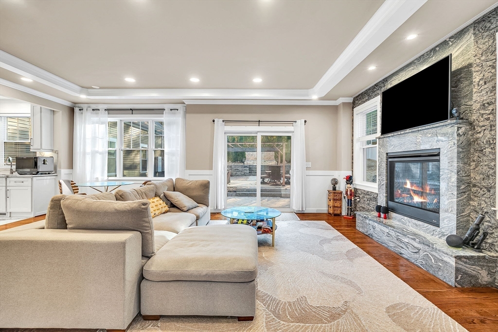 125 Union Street Natick, MA 01760 - Photo 10 of 38 a living room with fireplace furniture and a flat screen tv