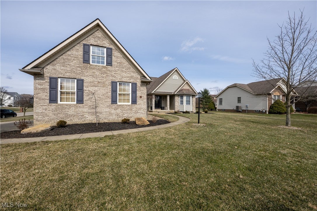 847 Lockwood Road Barberton, OH 44203 - Photo 3 of 29 View of front facade featuring brick siding and a front lawn