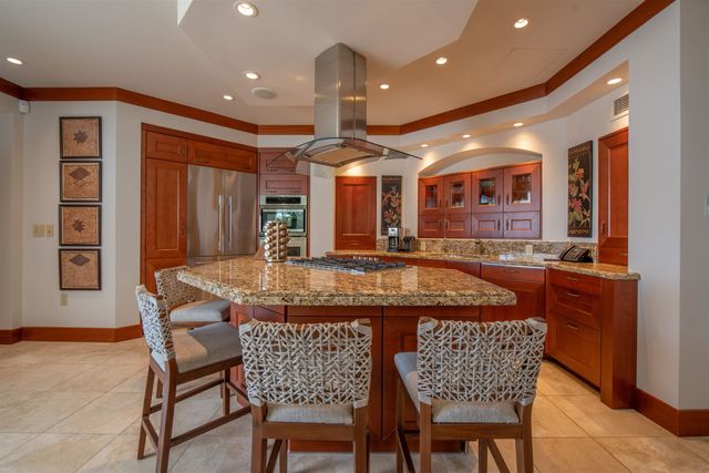 a dining room with furniture a chandelier and window