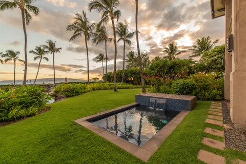 a front view of a house with a garden and plants