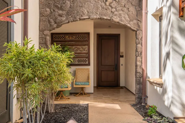 a bedroom with a bed and large windows