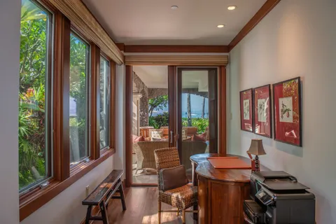 a bedroom with a bed and large windows