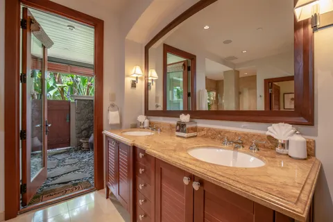 a spacious bathroom with a granite countertop sink and a mirror